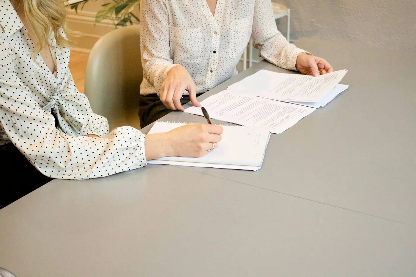 A client signing documents at a table