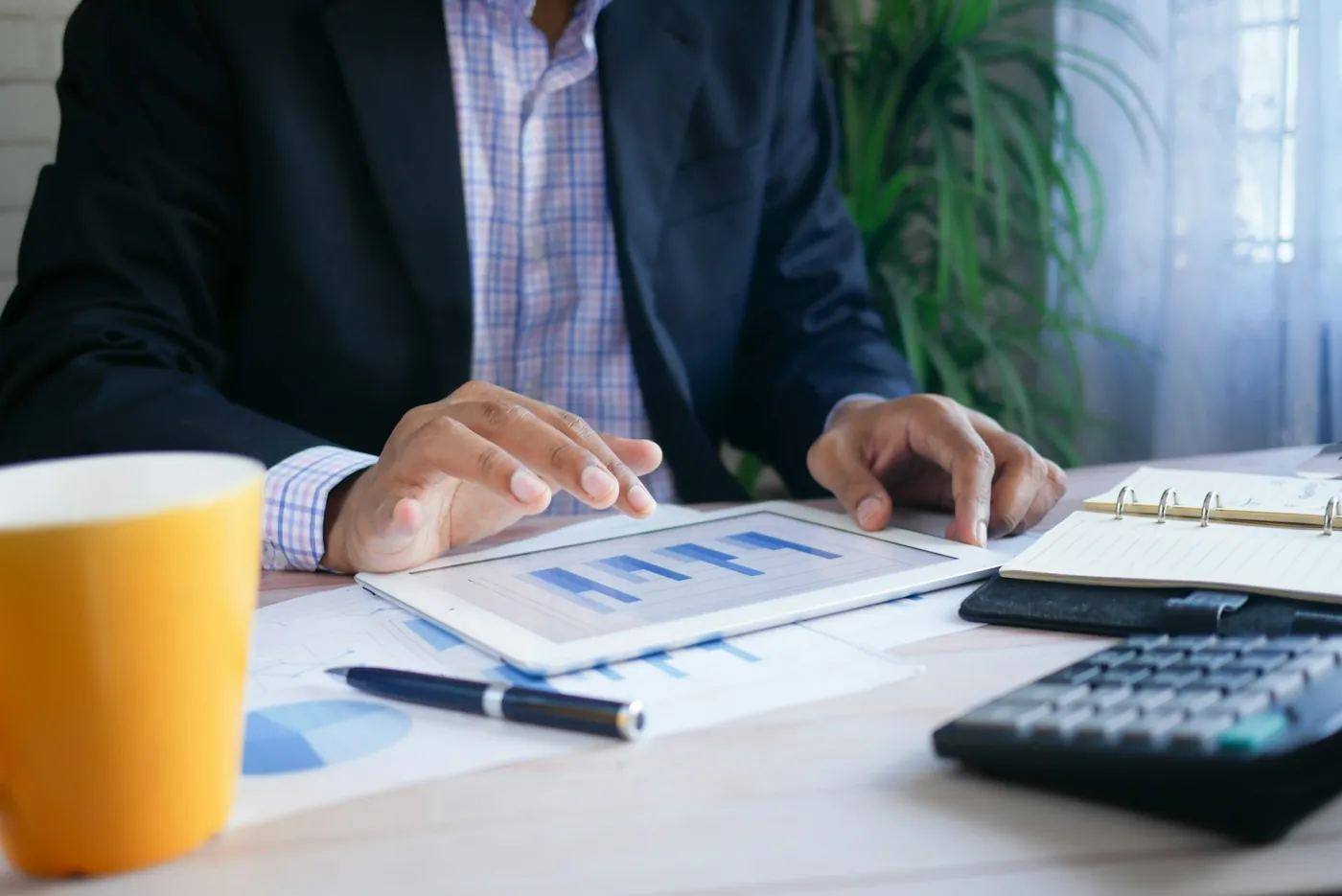 Reviewing charts on a tablet at a desk
